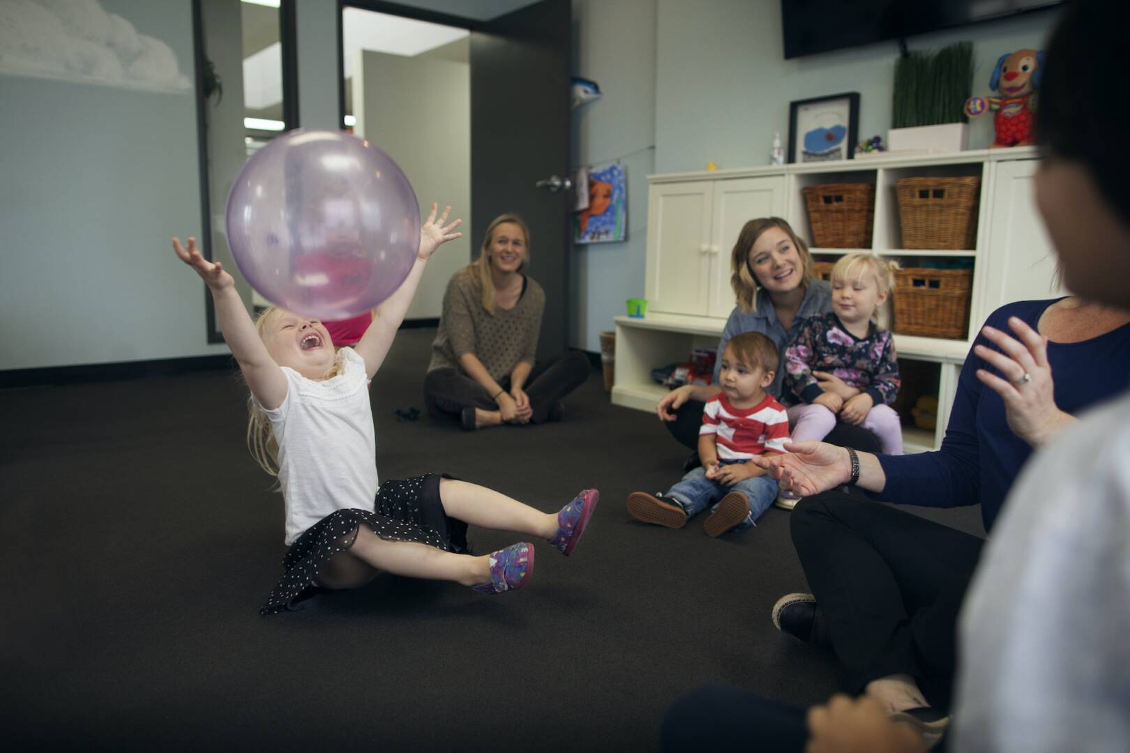 Children Playing With Nannies At Preschool